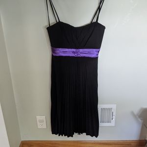 Black pleated dress with purple sash